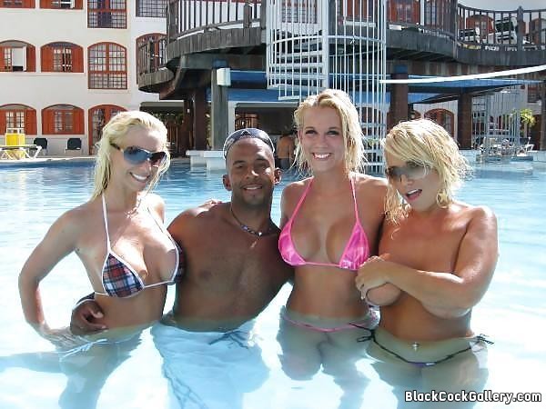3 super hot blonde chicks with one black guy in a swimming pool photo image